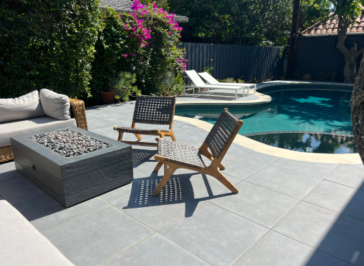 Bonfire and chairs next to swimming pool